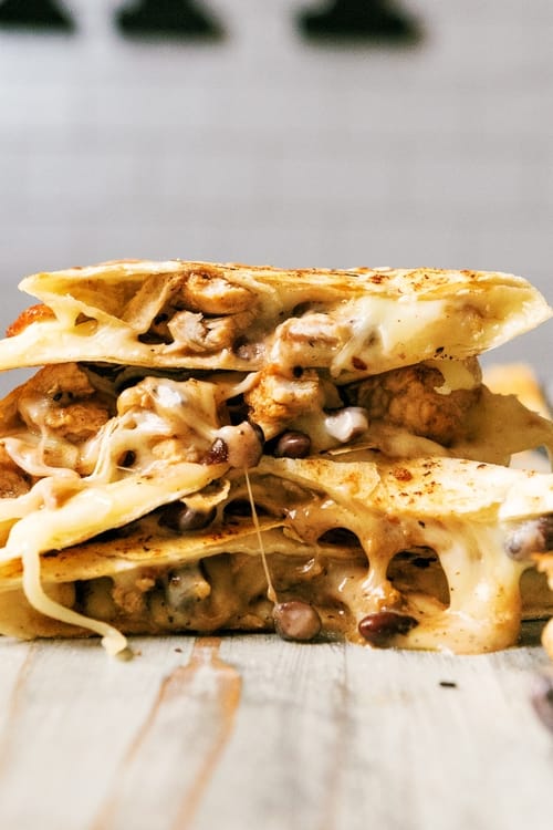 This delicious chicken quesadilla recipe is cooked on a Blackstone griddle flattop grill stuffed with savory chicken, melted Monterey cheese, and flavorful black beans. Its the perfect quick weeknight meal!