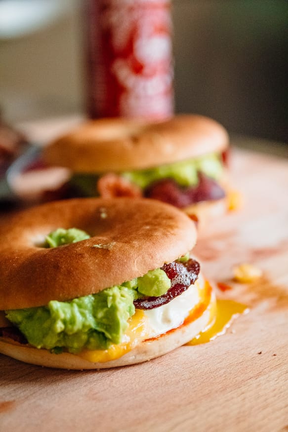 A breakfast bagel is the perfect way to start the morning! A beautifully runny egg with sriracha ketchup, guacamole, crisp bacon. 