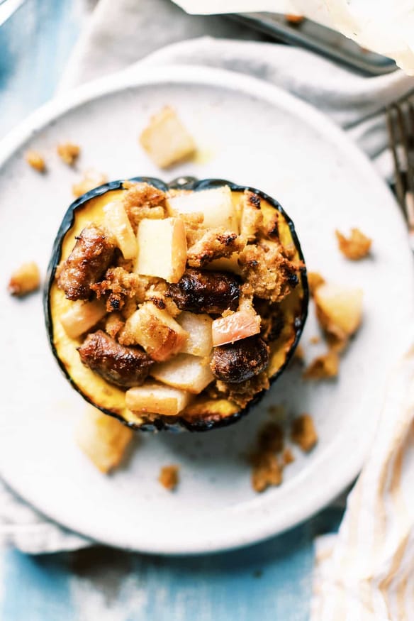 Breakfast Stuffing Acorn Squash loaded with maple sausage, pears and apples, and with a sweet maply syrup infused stuffing. 