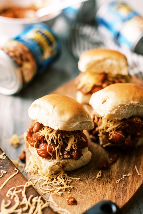 Easy weeknight chili dog sliders with from scratch 30 minute chili recipe. Perfect game day recipe or fun weeknight dinner!
