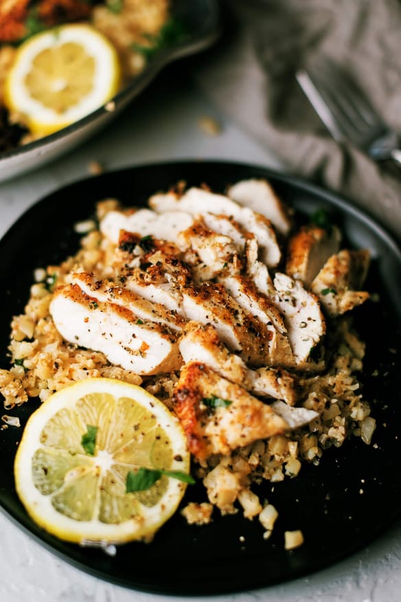 Chicken breast dredged in parmesan and pork rind panko in Italian seasonings sauteed in garlic and butter, topped on some cauliflower rice with some Italian parsley to finish.