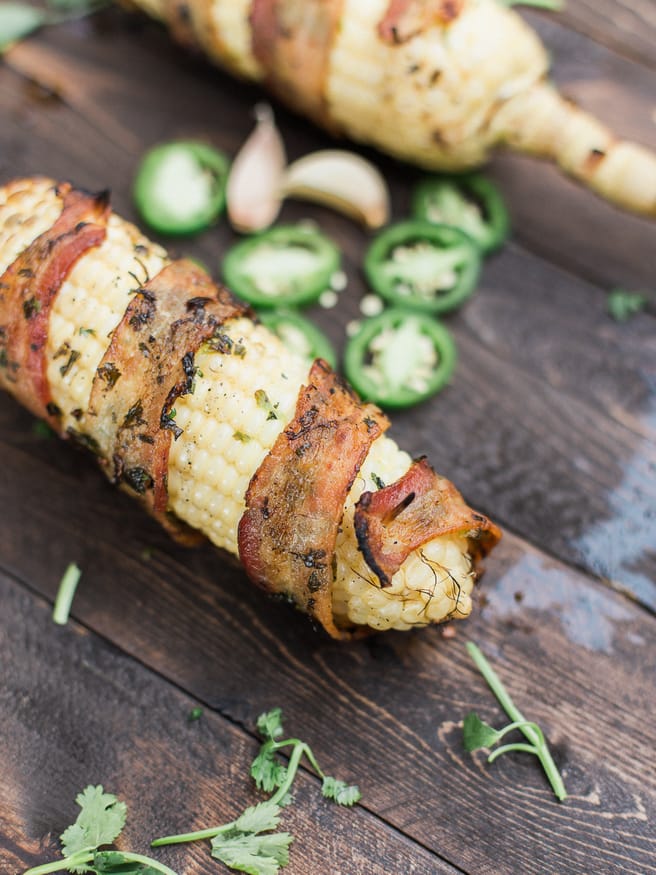 Bacon Wrapped Corn with a Jalapeno and Cilantro blend that will take your summer grilling to the next level! Full of flavor and spiciness! dadwithapan.com