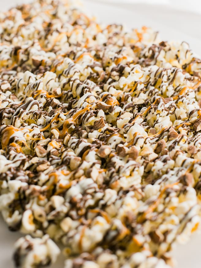 Zebra Popcorn recipe made a perfect companion for our Land Before Time Movie night! Drizzled with dark and white chocolate, caramel and chopped almonds!