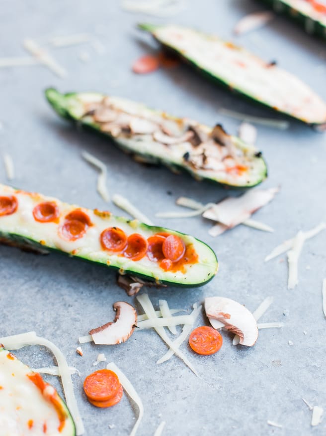 Zucchini boats on the grill with pizza toppings?! Loaded with mozzarella, pepperoni mushrooms and marinara sauce, these pizza zucchini boats are amazing!