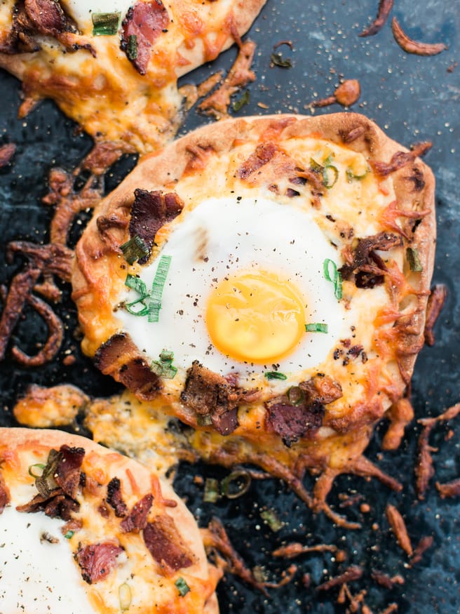 Breakfast pizza using Naan bread, loaded with cheese, bacon and topped with an egg! Hits the spot every morning!! 