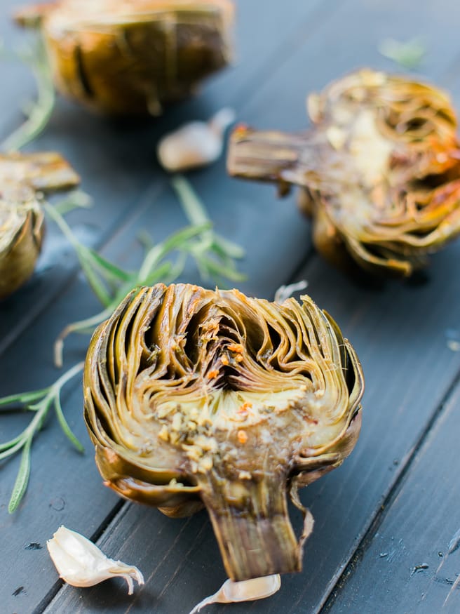 Roasted artichoke halves seasoned in a garlic and rosemary butter, the flavor is baked right in and is really amazing treat to eat as an appetizer or side!