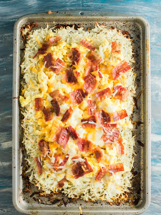Hashbrown Breakfast pizza with a hash brown crust, topped with scrambled eggs, cheese and bacon. Such a great Saturday morning breakfast!