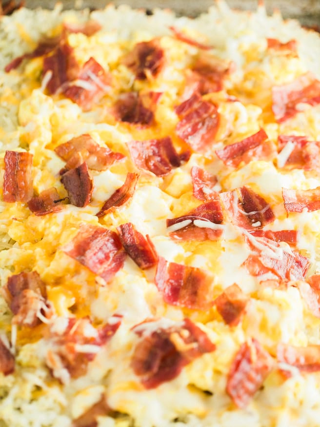 Hashbrown Breakfast pizza with a hash brown crust, topped with scrambled eggs, cheese and bacon. Such a great Saturday morning breakfast!