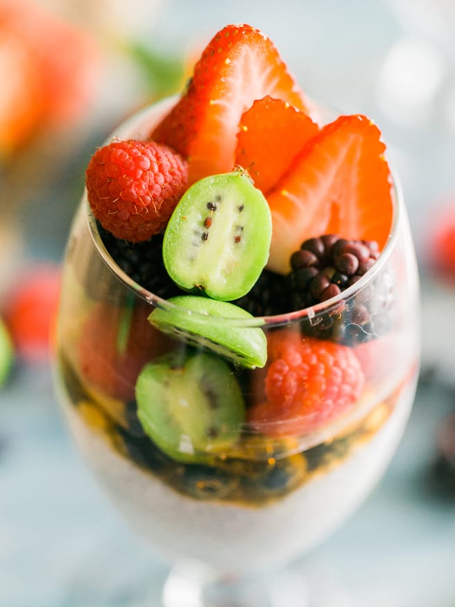 Chia parfait with a chia pudding and vanilla greek yogurt. Topped with honey, baby kiwis, and other fresh fruits. Makes a great quick and healthy breakfast!