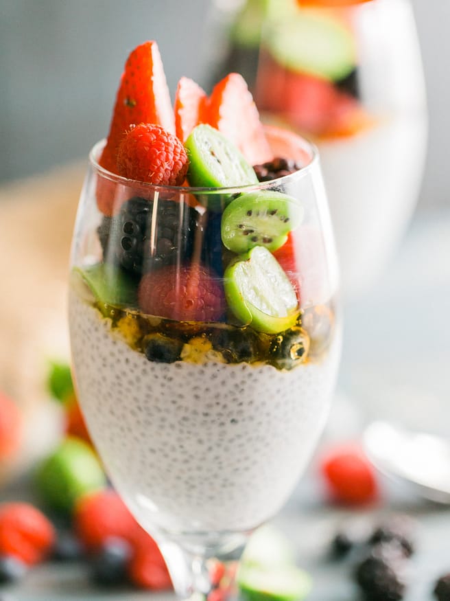 Chia parfait with a chia pudding and vanilla greek yogurt. Topped with honey, baby kiwis, and other fresh fruits. Makes a great quick and healthy breakfast!