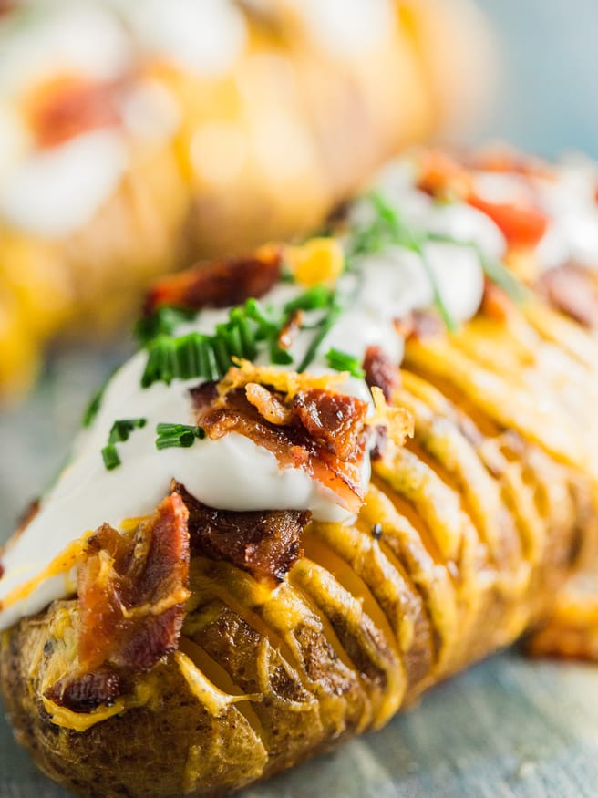 Hasselback potatoes loaded with cheese, bacon, sour cream, and fresh chopped chives, this is my new favorite way to have a baked potato!