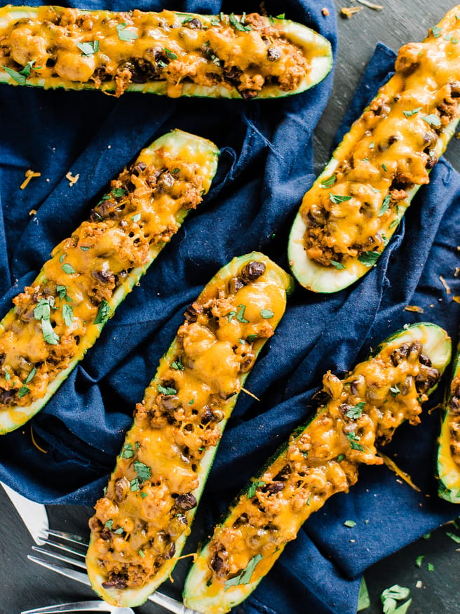 Stuffed Zucchini Boats with a ground turkey filling. Turkey simmered with salsa, Mexican inspired seasoning, and black beans, topped with melted cheese!