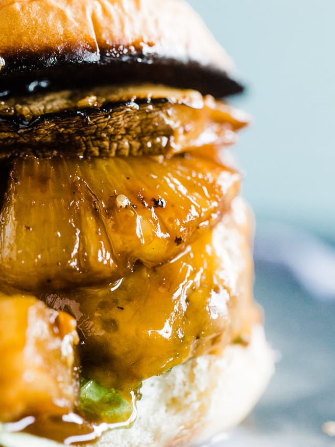Teriyaki Burger topped with a Grilled pineapple, portabella mushroom, simmering in teriyaki sauce and topped on toasted Hawaiian hamburger rolls. 