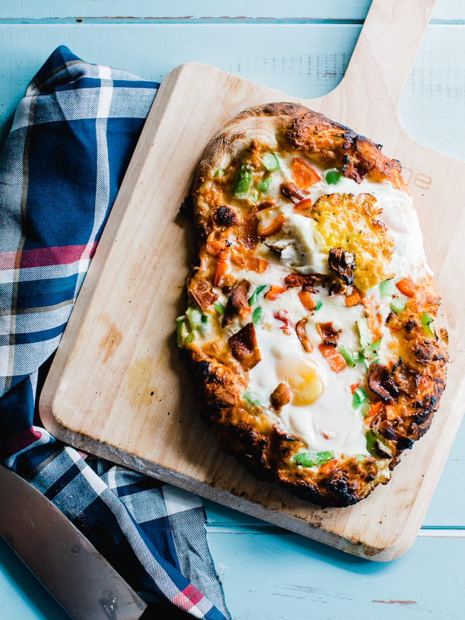 Breakfast Pizza meets Denver omelette. Topped with egg, bacon, bell peppers and cheese. A great way to start the weekend is with a breakfast pizza! 