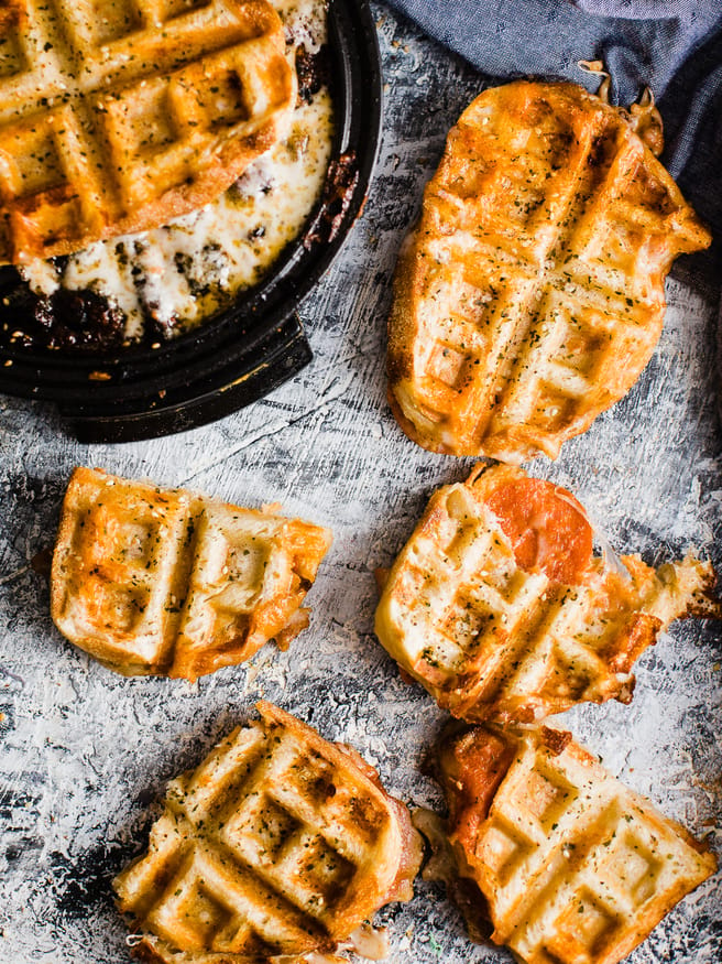 Pepperoni Pizza meets grilled cheese, meets waffle Iron making the best concoction known to man: Pepperoni Pizza Waffle Sandwich!