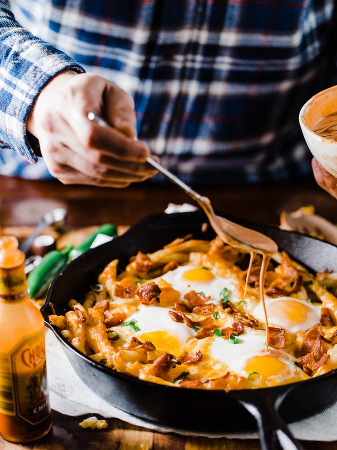 These loaded breakfast fries are topped with everything dreams are made of, bacon cheese, green onion, sunny side up eggs and a spicy aioli!