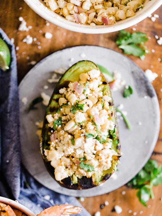 Grilled Avocado Bowl with Elote cut off the cob and topped with some grilled shrimp. This makes a great side dish or light lunch! 