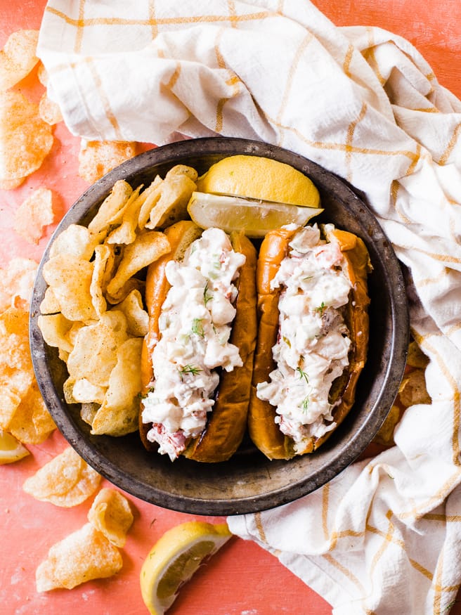 Smoked lobster roll with old bay seasoned chips is the best way to enjoy the summer! Smoked  lobster on a traeger grill and loaded on toasted brioche buns. 