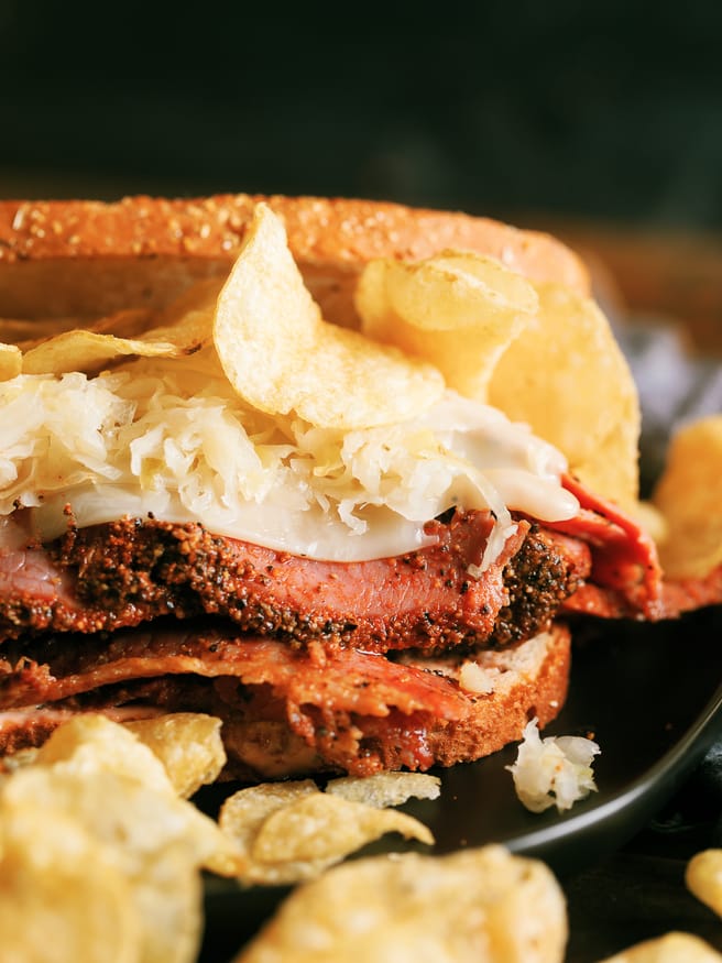 A Pastrami Reuben grilled on a panini press with crunchy kettle cooked chips. My absolute favorite way to do pastrami sandwiches!