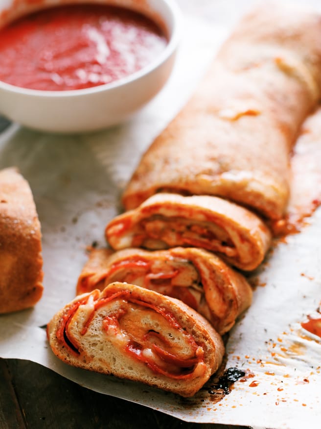 Easy to make Stromboli, loaded with pepperoni, mushroom and cheese, layered so that everyone has their favorite toppings in their own slice!