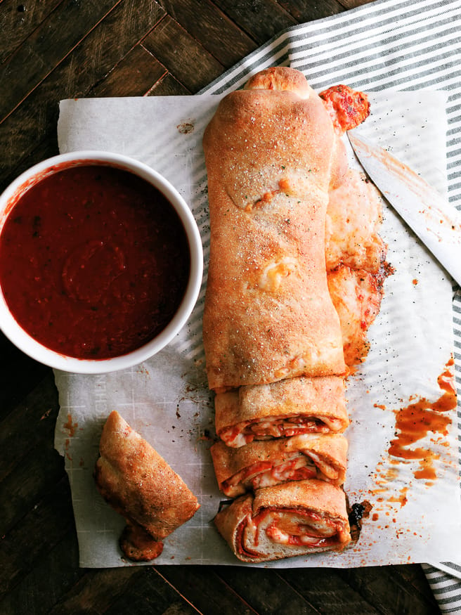 Easy to make Stromboli, loaded with pepperoni, mushroom and cheese, layered so that everyone has their favorite toppings in their own slice!