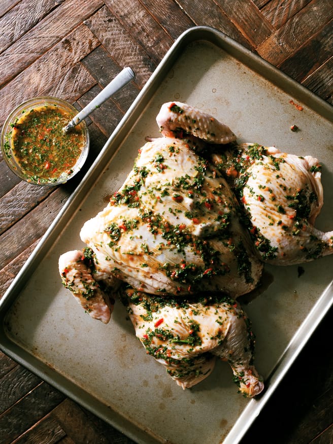 Chimichurri spatchcock chicken cooked on a wood fire grill. Tons of bold, zesty flavors and is a great weekend dinner idea