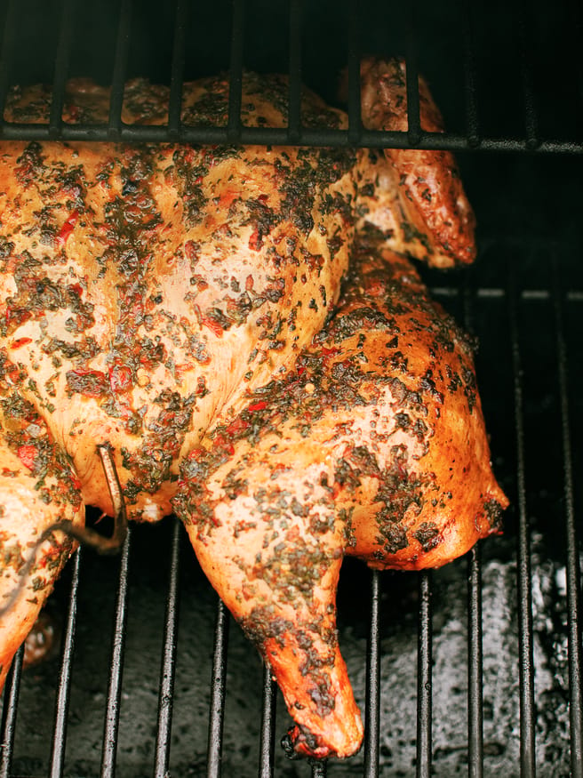 Chimichurri spatchcock chicken cooked on a wood fire grill. Tons of bold, zesty flavors and is a great weekend dinner idea