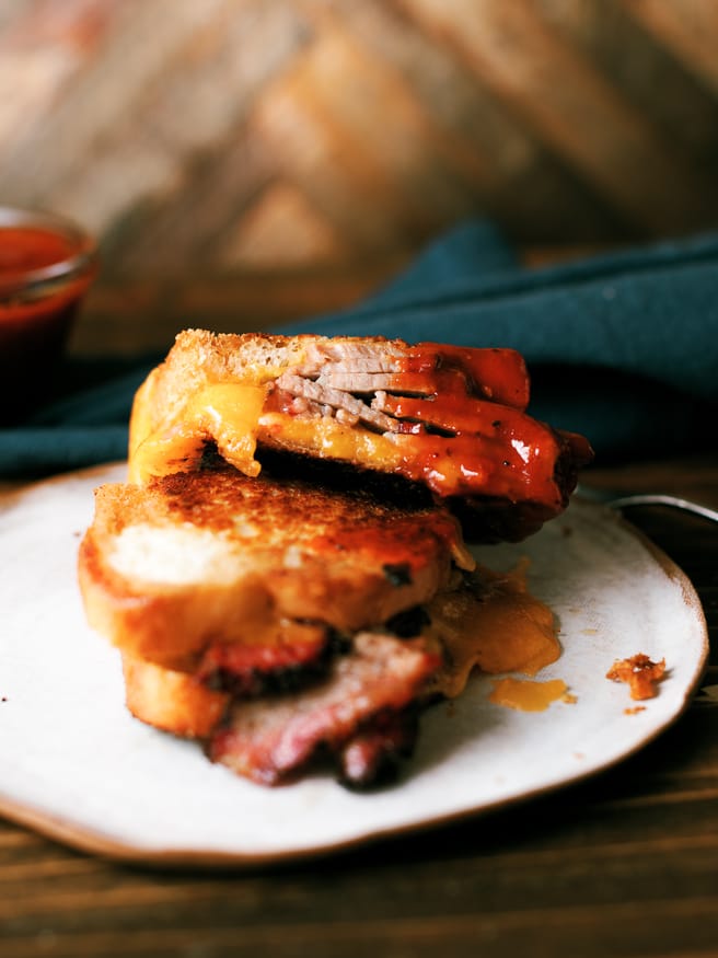 Smoky slices of brisket flat in between cheese and bread, to make a brisket grilled cheese sandwich that's a perfect use of leftover brisket!!