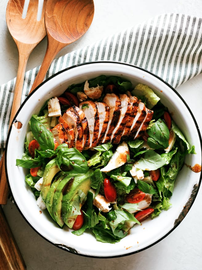 Grilled chicken caprese salad with balsamic marinaded chicken topped with fresh mozzarella, basil and cherry tomatoes. This is the perfect summer salad!