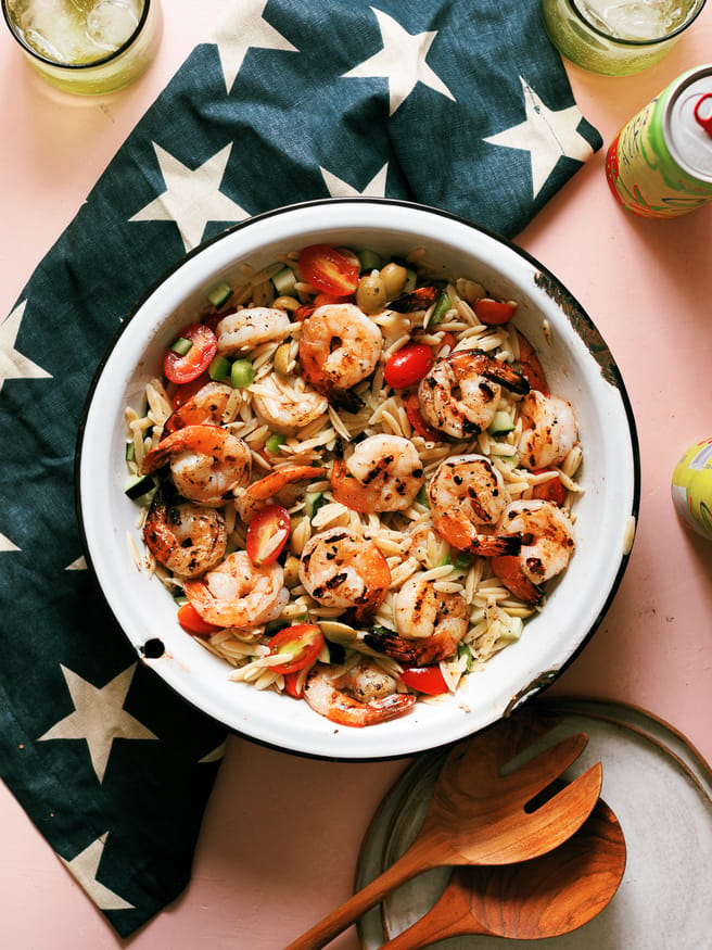Zesty Grilled Shrimp, orzo pasta coated in an oil and vinegar based dressing with cucumber bell pepper cherry tomatoes. One of my favorite summer meals!