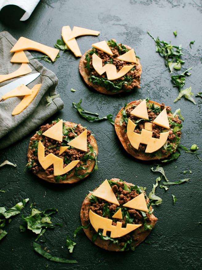  Jack O lantern tostadas are  topped  with beans, taco-seasoned ground beef and cheese cut out into fun jack-o-lantern shapes. Great halloween night dinner!
