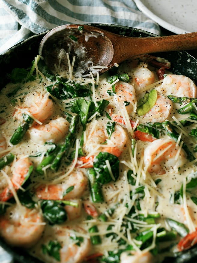 This Keto Shrimp Alfredo is a simple from scratch Alfredo sauce with sauteed shrimp asparagus and spinach. Whats even better is it can double for a pasta as well feeding the carb-lovers in your family all at once! 
