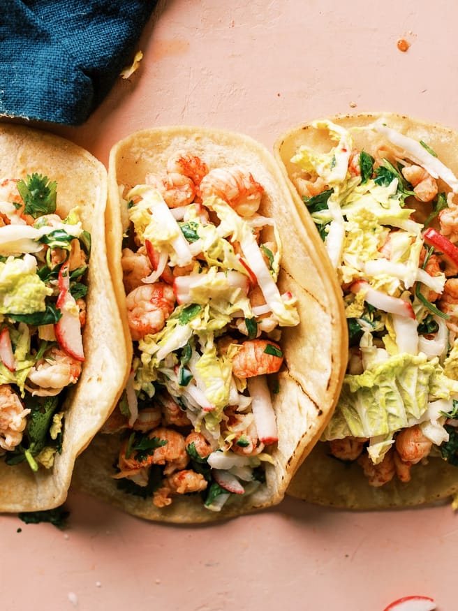 Cilantro lime lobster tacos with a zesty and spicy slaw mad with napa cabbage, cilantro, lime and serrano peppers. It's light fresh, and has little heat that is perfect for summer!