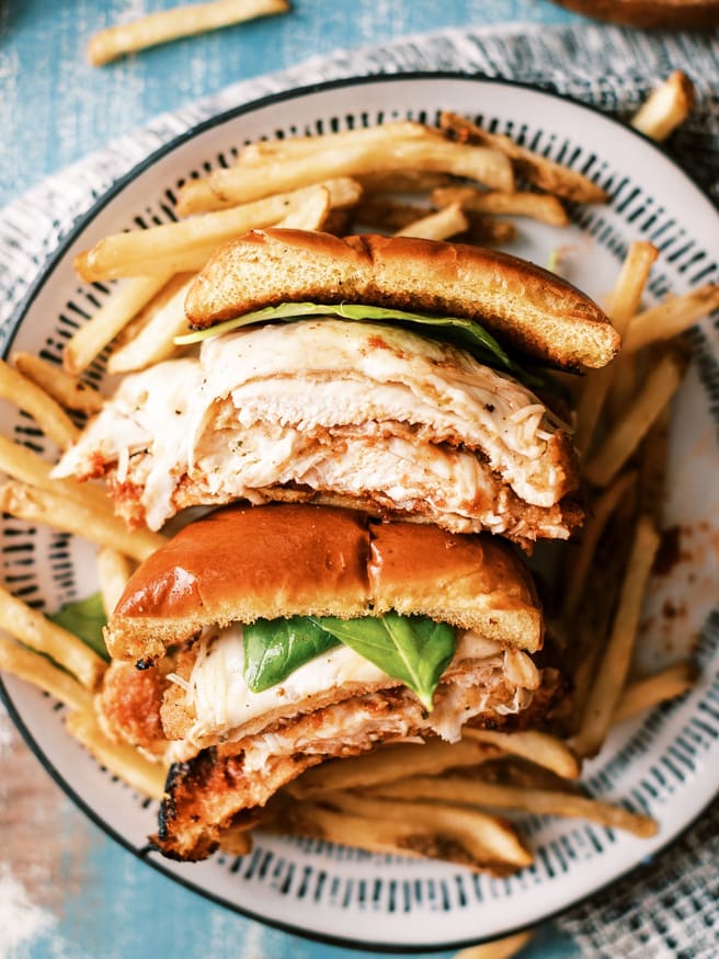 Chicken Parmesan Sandwiches in the theme of a burger. They're a delicious way to change up your chicken Parmesan and so fun to eat!

