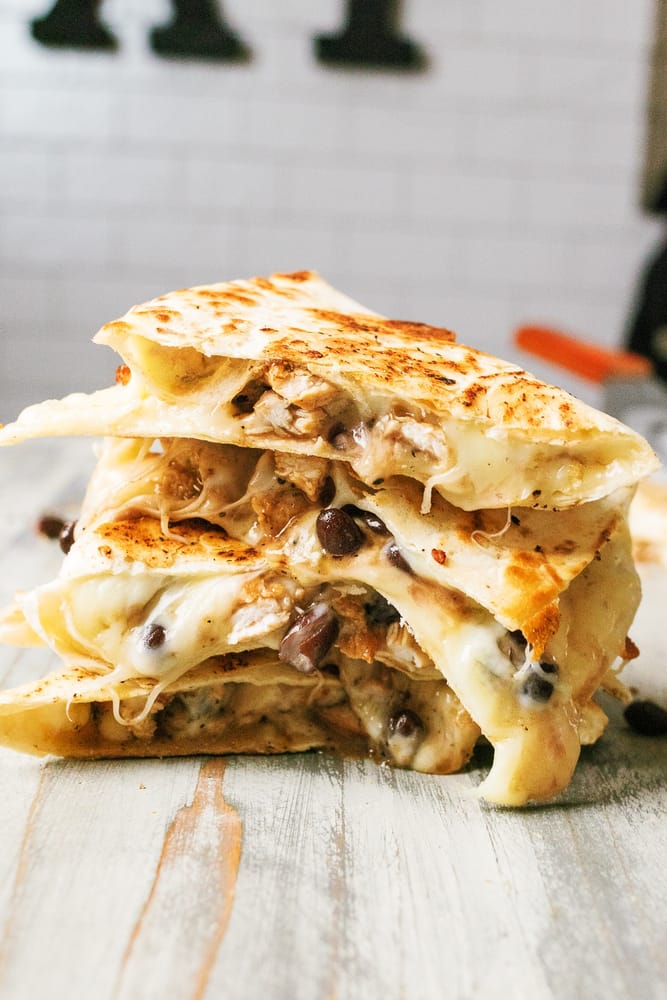 This delicious chicken quesadilla recipe is cooked on a Blackstone griddle flattop grill stuffed with savory chicken, melted Monterey cheese, and flavorful black beans. Its the perfect quick weeknight meal!