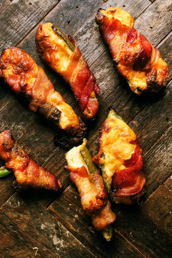 Discover the ultimate recipe for Smoked Buffalo Chicken Jalapeno Poppers, a fiery fusion of shredded chicken, cream cheese, and Frank's Red Hot Sauce wrapped in smoky bacon. 