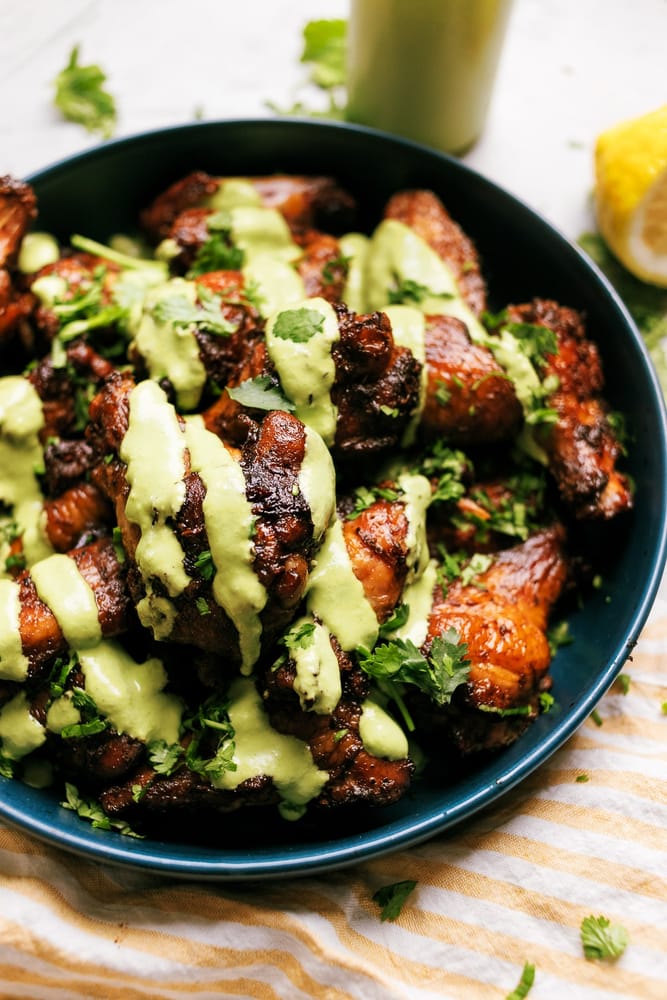 Smoked Peruvian Chicken Wings drizzled with a Aji Verde style spicy green sauce. Umami flavors, paired with a bright zesty and spicy flavors!