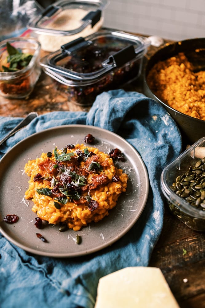 This Creamy Pumpkin Risotto is a fall must! loaded with bacon, parmesan and topped with crispy sage, pumpkin seeds and dried cranberries