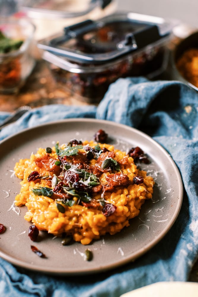 This Creamy Pumpkin Risotto is a fall must! loaded with bacon, parmesan and topped with crispy sage, pumpkin seeds and dried cranberries