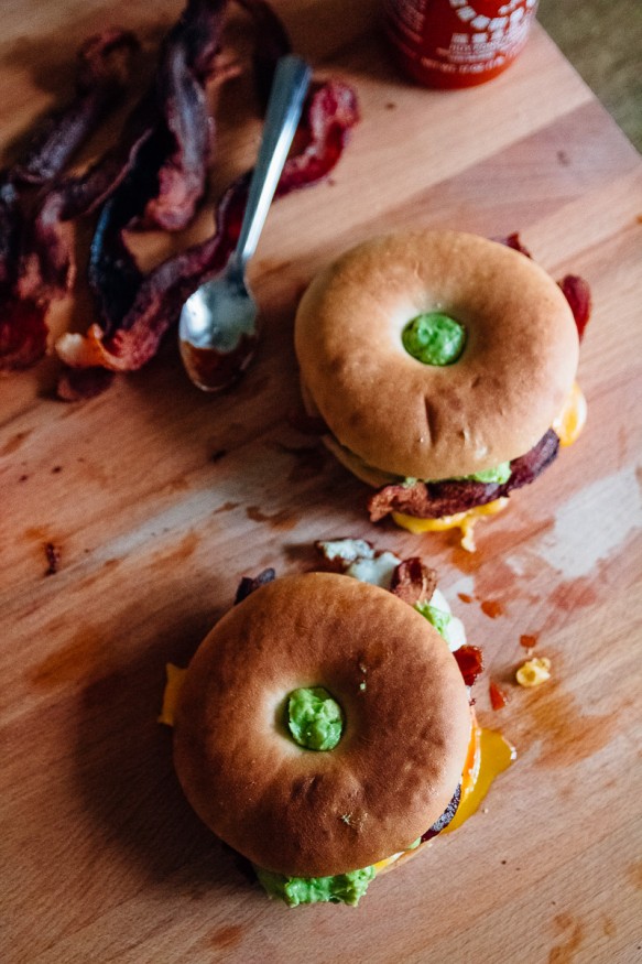 A breakfast bagel is the perfect way to start the morning! A beautifully runny egg with sriracha ketchup, guacamole, crisp bacon. 