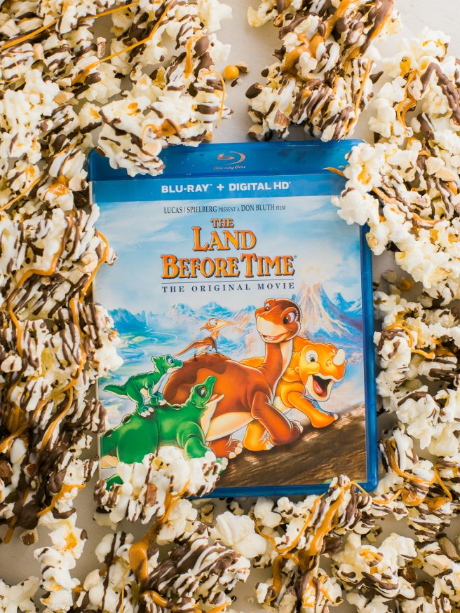 Zebra Popcorn recipe made a perfect companion for our Land Before Time Movie night! Drizzled with dark and white chocolate, caramel and chopped almonds!