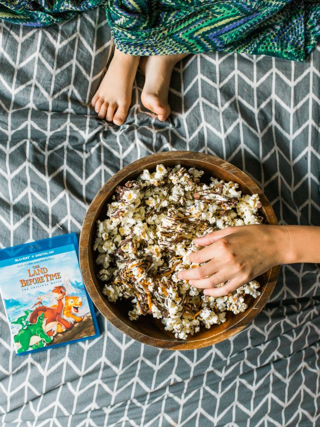 Zebra Popcorn recipe made a perfect companion for our Land Before Time Movie night! Drizzled with dark and white chocolate, caramel and chopped almonds!