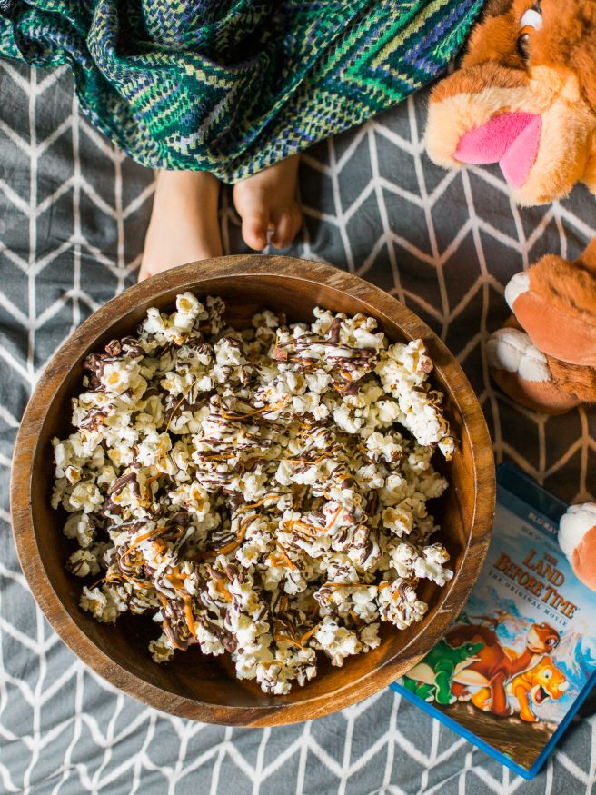 Zebra Popcorn recipe made a perfect companion for our Land Before Time Movie night! Drizzled with dark and white chocolate, caramel and chopped almonds!