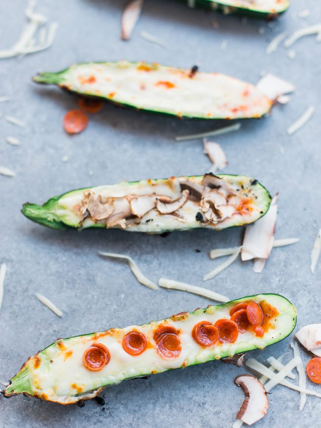 Zucchini boats on the grill with pizza toppings?! Loaded with mozzarella, pepperoni mushrooms and marinara sauce, these pizza zucchini boats are amazing!