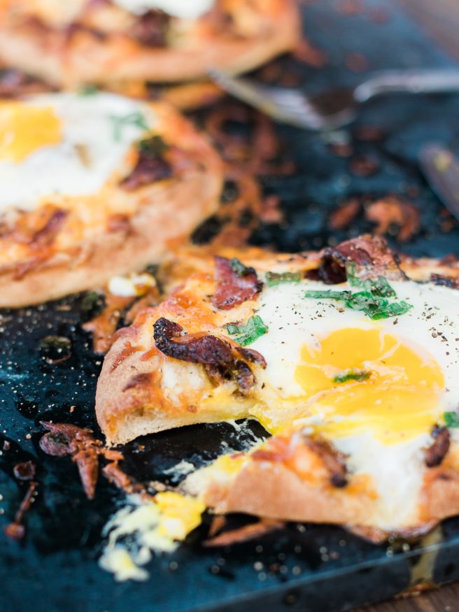 Breakfast pizza using Naan bread, loaded with cheese, bacon and topped with an egg! Hits the spot every morning!! 