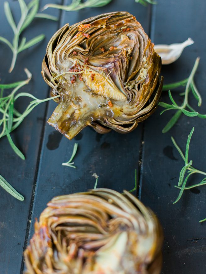 Roasted artichoke halves seasoned in a garlic and rosemary butter, the flavor is baked right in and is really amazing treat to eat as an appetizer or side!