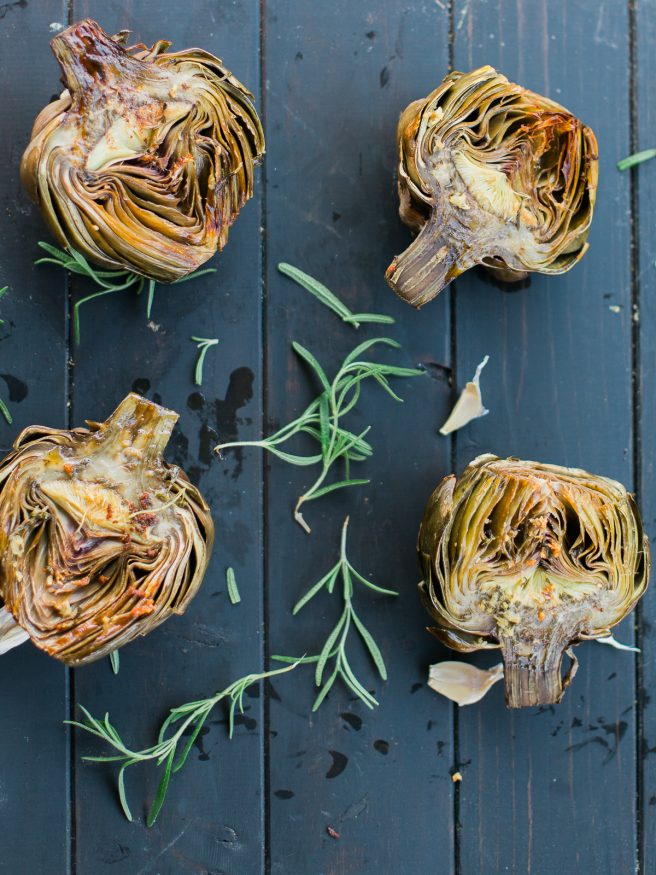 Roasted artichoke halves seasoned in a garlic and rosemary butter, the flavor is baked right in and is really amazing treat to eat as an appetizer or side!