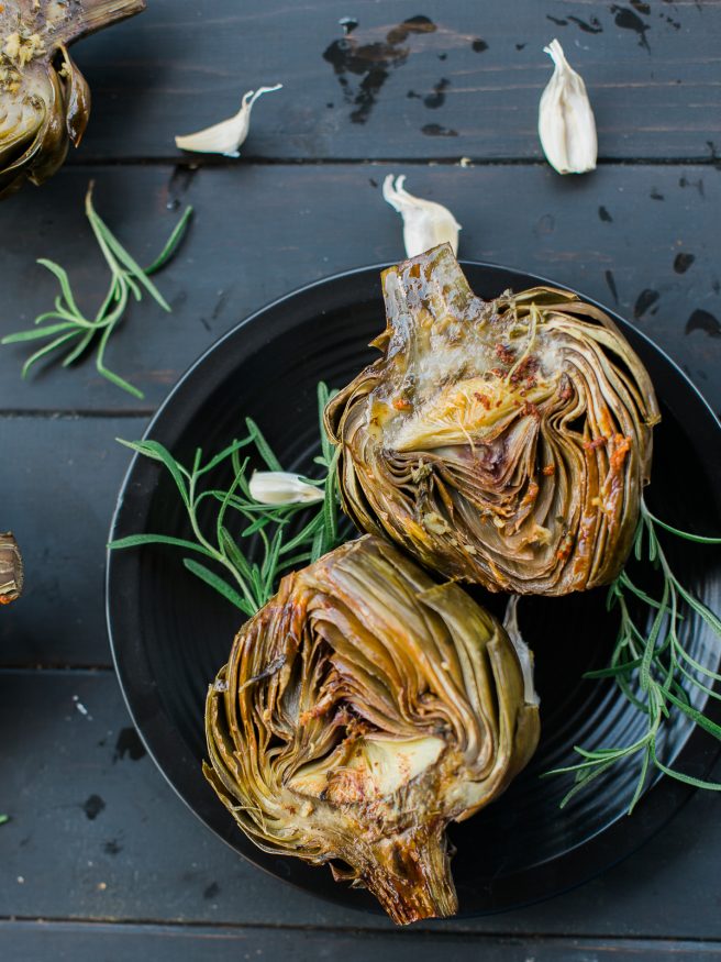 Roasted artichoke halves seasoned in a garlic and rosemary butter, the flavor is baked right in and is really amazing treat to eat as an appetizer or side!