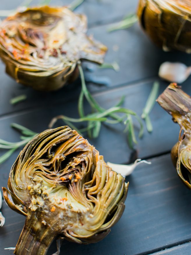 Roasted artichoke halves seasoned in a garlic and rosemary butter, the flavor is baked right in and is really amazing treat to eat as an appetizer or side!