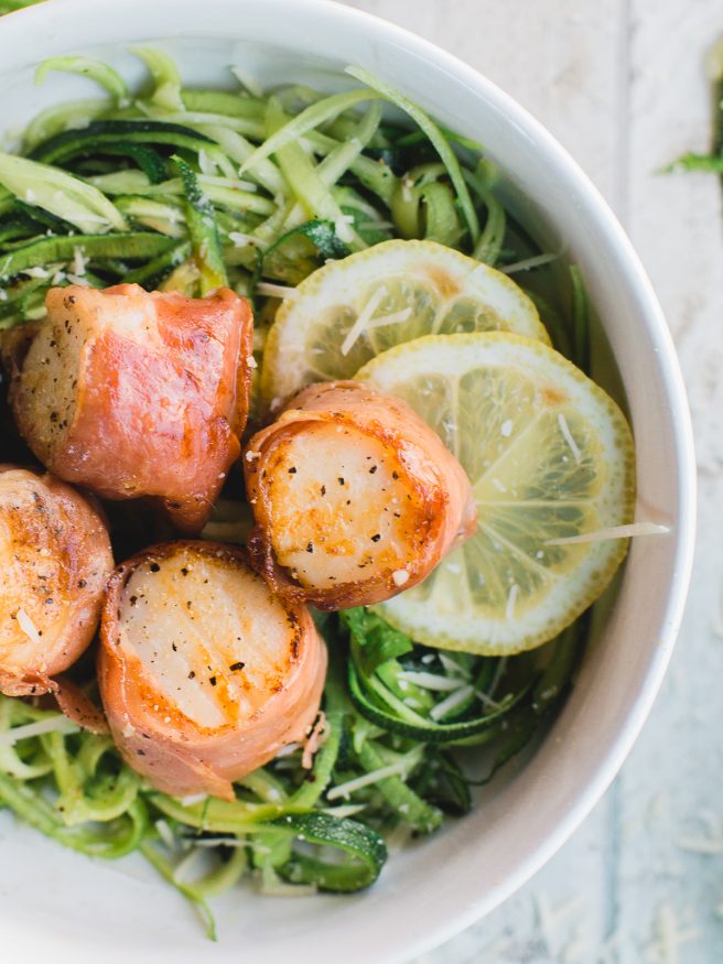 Prosciutto Wrapped scallops served on Basil Parmesan Zoodles, this dish is light and fresh, and is full of flavor! 